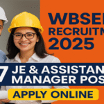 Two young engineers wearing safety helmets standing confidently with documents alongside WBSEDCL Recruitment 2025 announcement showing 447 JE and Assistant Manager posts with an Apply Online button